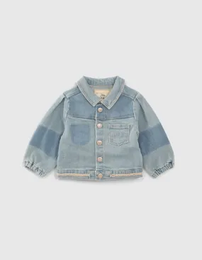 Blue denim jacket with braided trim for baby girl.